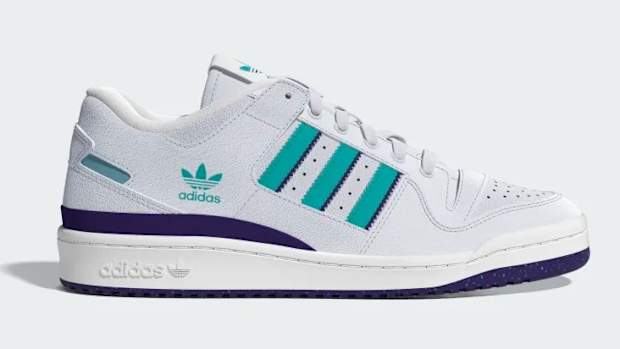 Side view of a white, teal, and purple adidas shoe.
